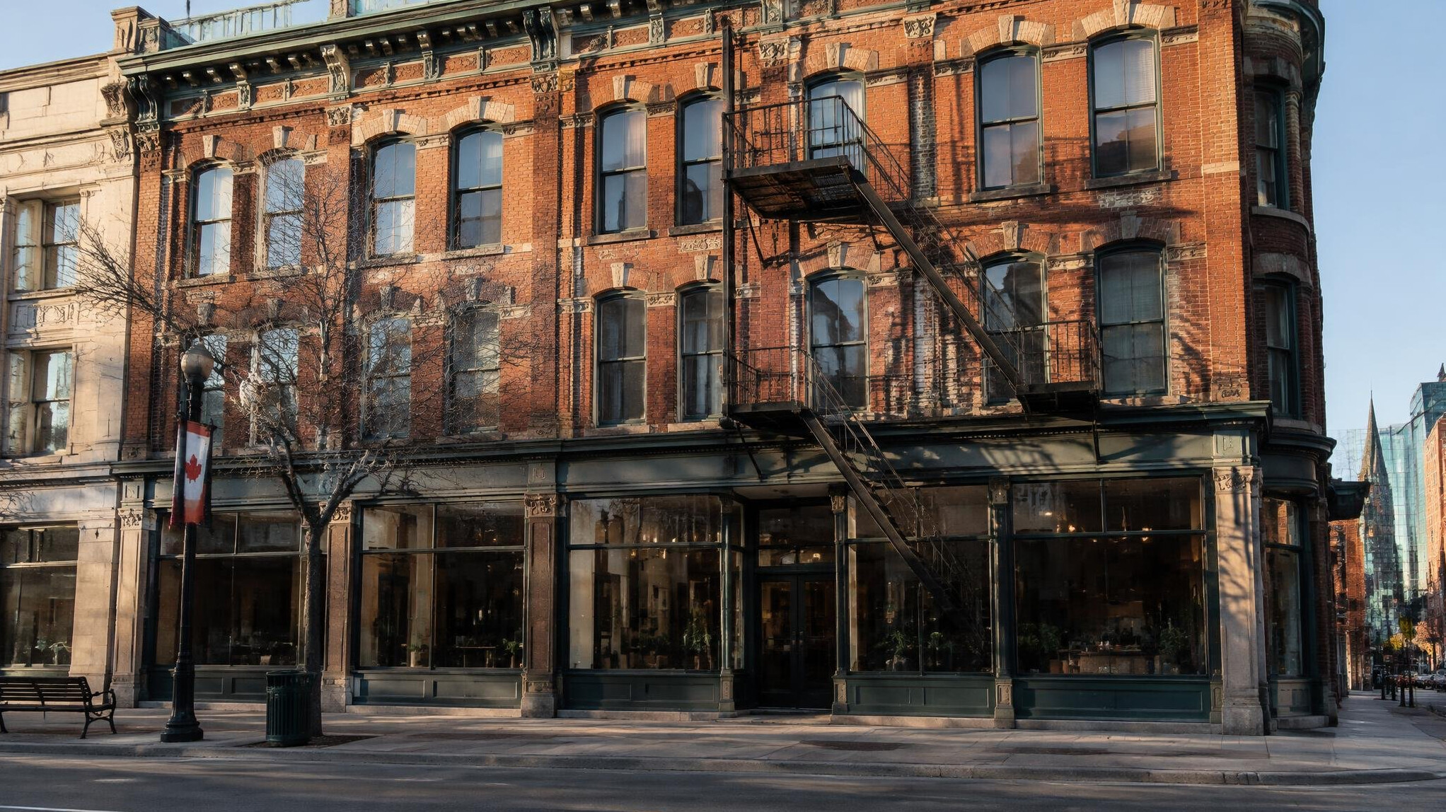Historic brick building facade with large windows on an urban street