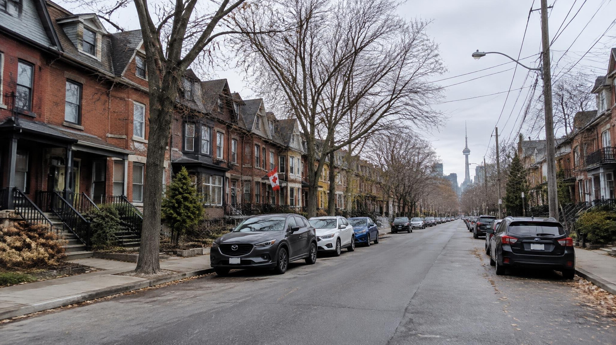 Row of brick townhouses on a quiet Canadian city street